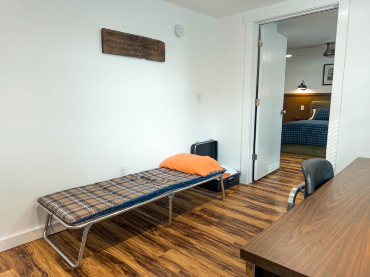Fold-out cot near the doorway to the bedroom