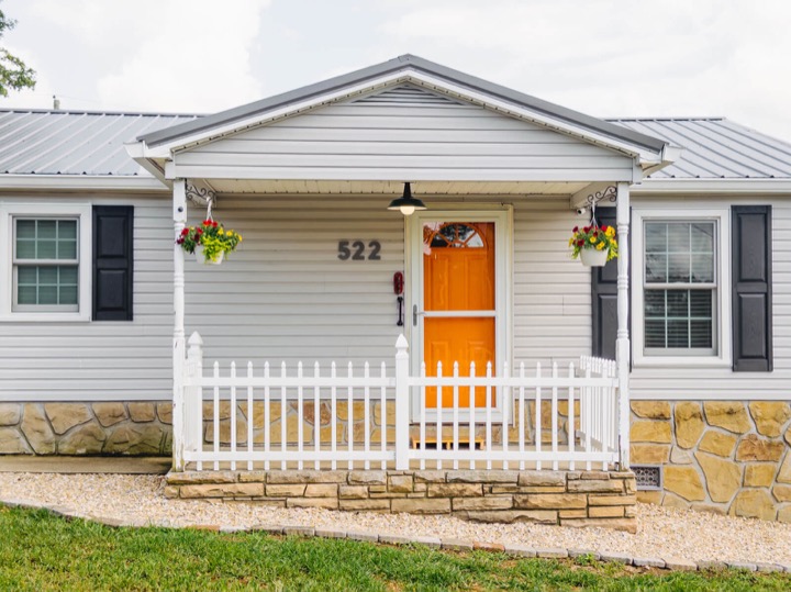 White front porch and orange door at The Rambler’s Rest in Pigeon Forge