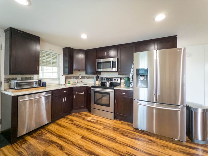 Wide view of the fully equipped kitchen and stainless appliances