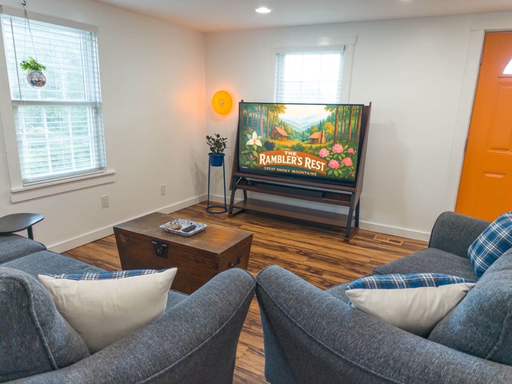 Vintage-inspired living room seen from behind the gray armchairs