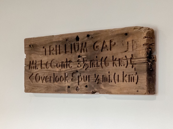 Rustic wooden trail sign displayed in the home